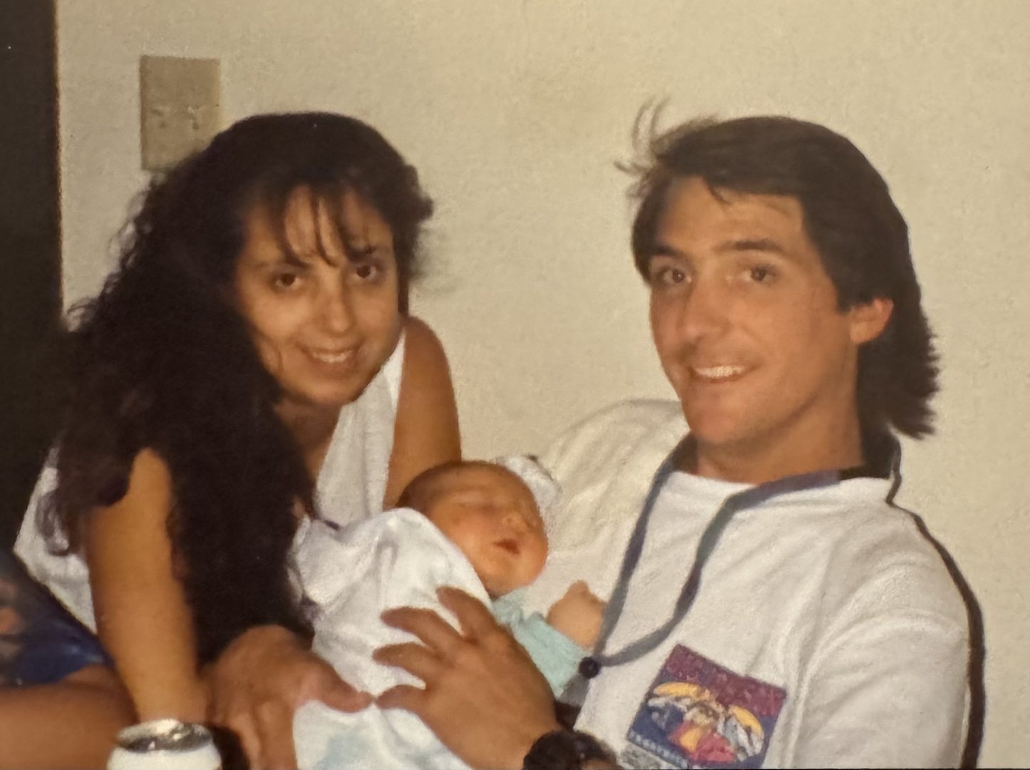 Newborn John held by his mother and father in the hospital, 1994.