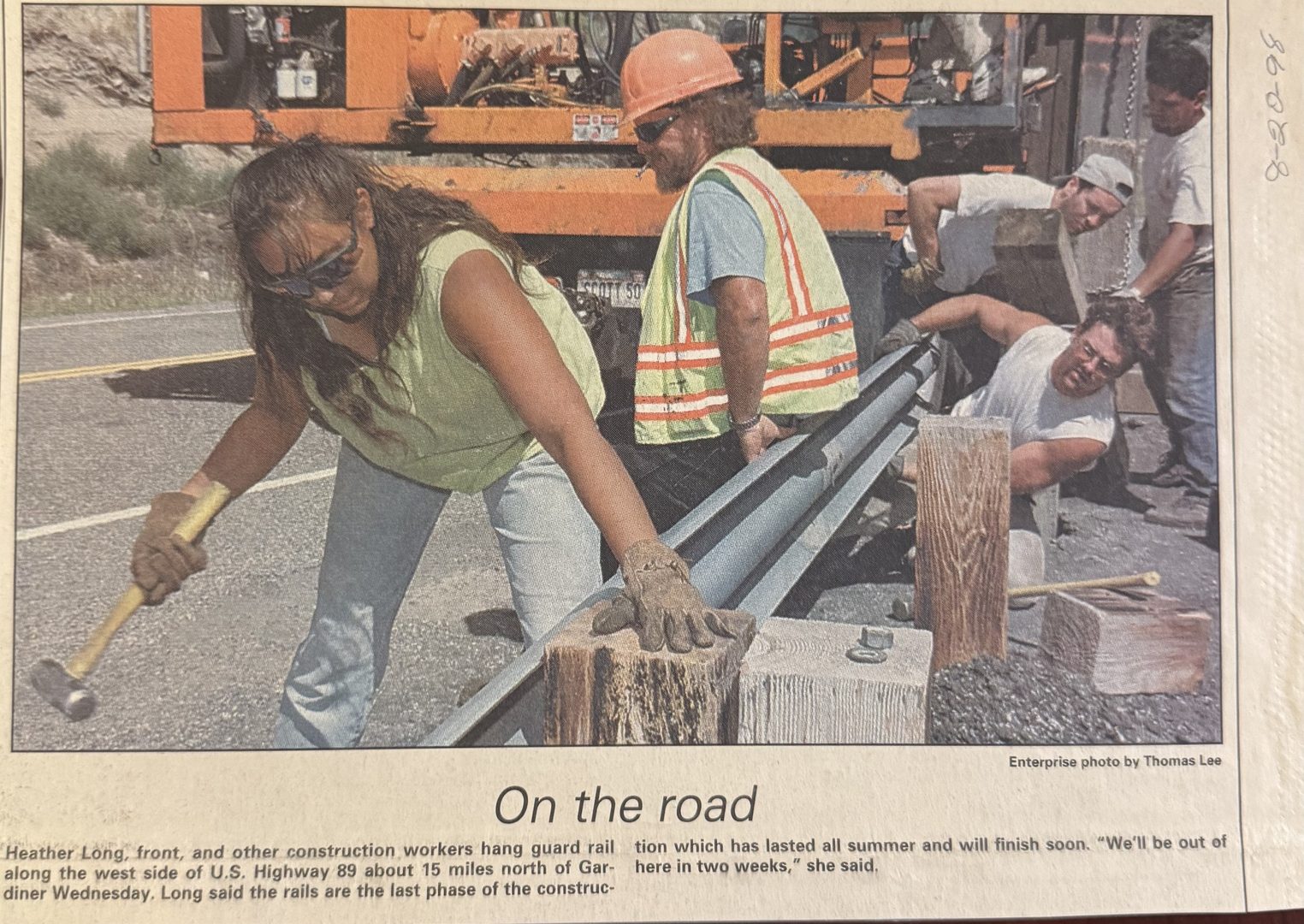 Billings Gazette clipping: Heather Long swinging a sledge on Highway 89 north of Gardiner, 1998.