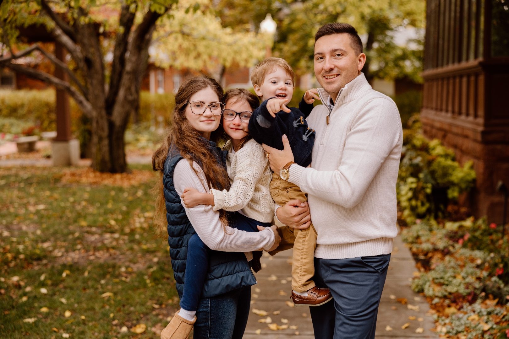 John and Kaylee with their daughter and son in a warm autumn family portrait.